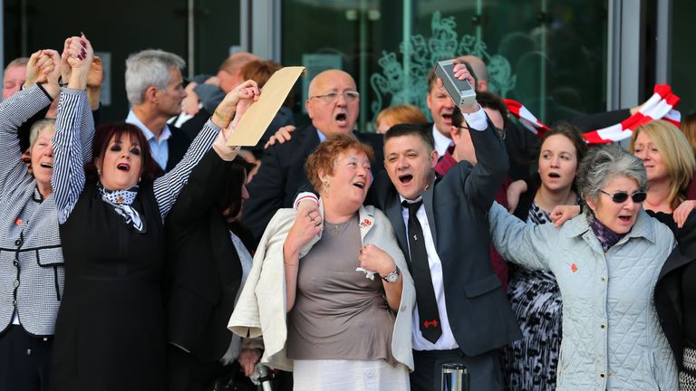 Relatives of the Hillsborough victims sing 'You'll never walk alone' as they depart the court