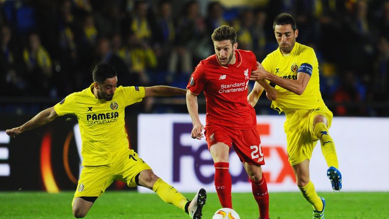 Adam Lallana of Liverpool takes on Jaume (L) and Bruno of Villarreal (R) during the UEFA Europa League semi final first leg 
