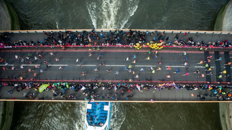 Runners cross the River Thames via Tower Bridge during the Virgin London Marathon 2016