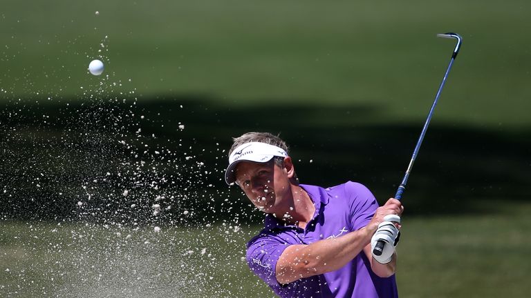 Luke Donald of England plays his third shot from the bunker 