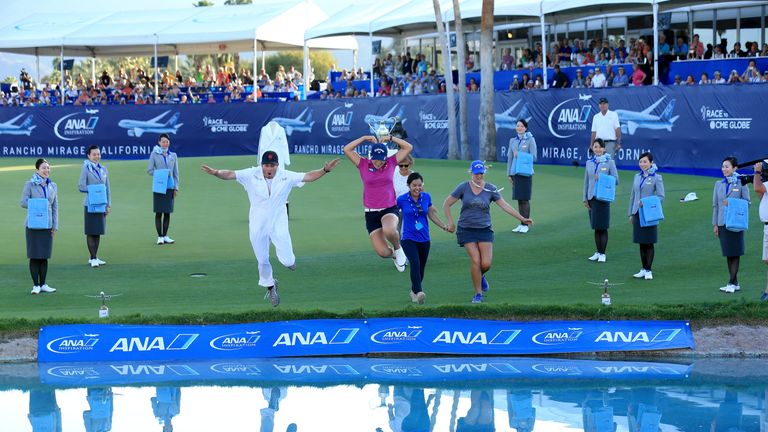 Lydia Ko of New Zealand leads the leap into Poppie's Pond at the 18th green after her victory in the final round of the 2016 ANA Inspiration