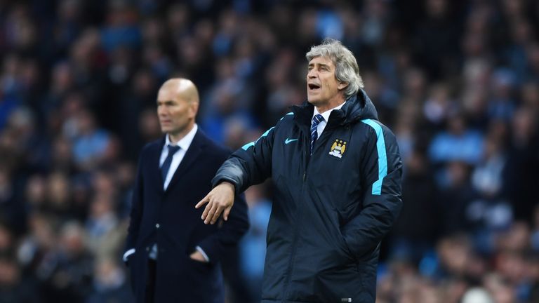 MANCHESTER, ENGLAND - APRIL 26:  Manuel Pellegrini, manager of Manchester City directs his players as Head Coach Zinedine Zidane of Real Madrid CF looks on