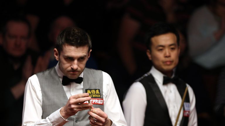 Mark Selby (L) of England and Marco Fu of Hong Kong during their World Championship semi-final