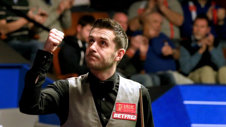 Mark Selby celebrates winning his match with Kyren Wilson