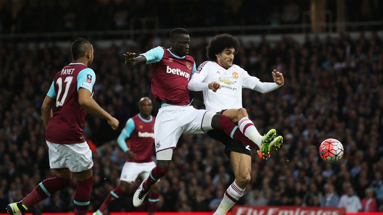 LONDON, ENGLAND - APRIL 13:  Marouane Fellaini of Manchester United is challenged by Cheikhou Kouyate of West Ham United during the Emirates FA Cup, sixth 