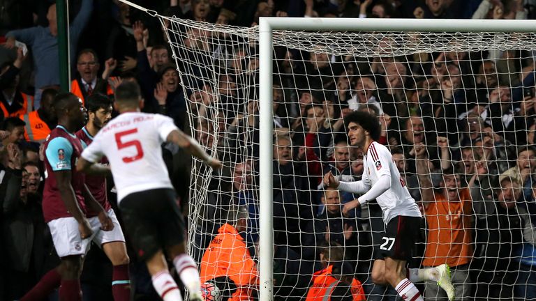 Manchester United's Marouane Fellaini (right) celebrates scoring their second goal of the game during the Emirates FA Cup, Quarter Final Replay match at Up