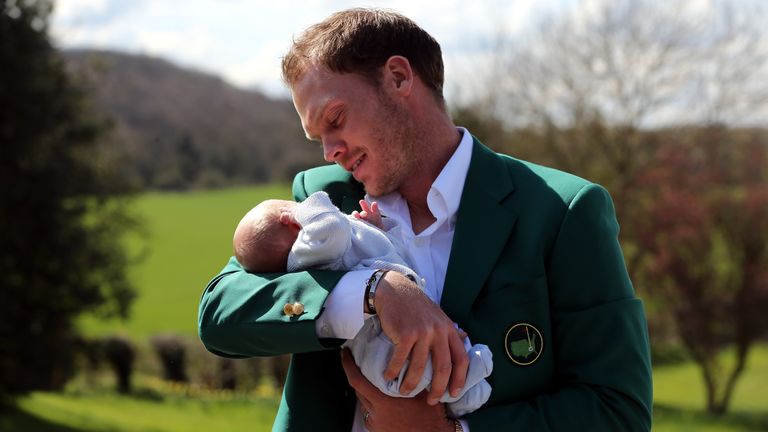 Masters champion Danny Willett poses for photographs wearing the famous green jacket with son Zachariah at Lindrick Golf Club