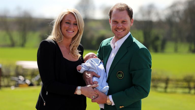 Masters champion Danny Willett poses for photographs wearing the famous green jacket with wife Nicole and son Zachariah at Lindrick Golf Club