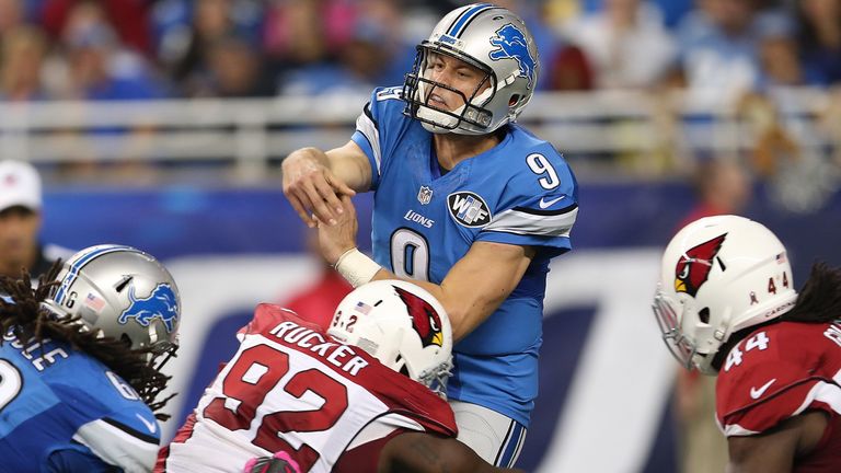 DETROIT MI - OCTOBER 11: Matthew Stafford of the Detroit Lions is hit by Frostee Rucker of the Arizona Cardinals in the second quarter on October 11, 2015 