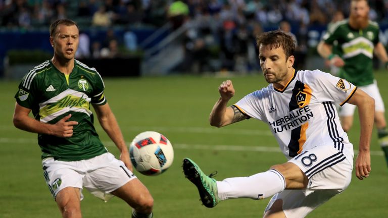CARSON, CALIFORNIA - APRIL 10: Mike Magee #18 of Los Angeles Galaxy shoots on goal against the Los Angeles Angels of Anaheim Jack Jewsbury #13 of the Portl