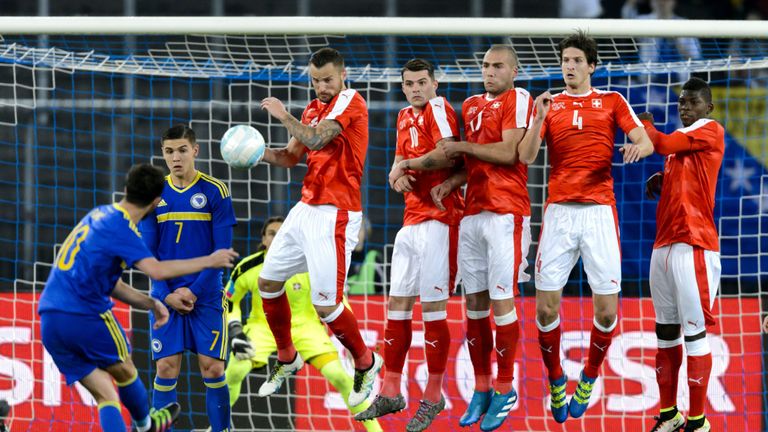 Bosnia-Herzegovina's midfielder Miralem Pjanic (L) kicks the ball to score the second goal during the friendly football match against Switzerland