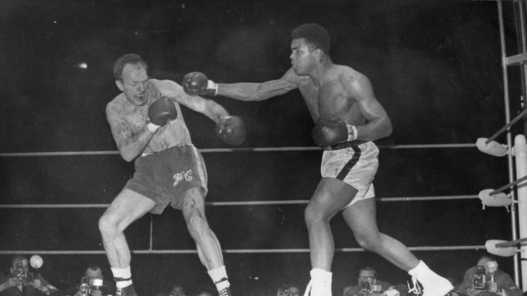 American boxer and world heavyweight champion Muhammad Ali throws a long right to British challenger Henry Cooper's injured left eye