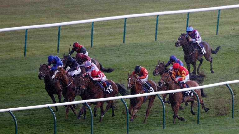 Frankie Dettori riding Nathra (C, red) win the Lanwades Stud Nell Gwyn Stakes at Newmarket 