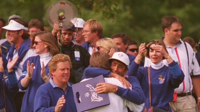  NICK FALDO OF ENGLAND IS HUGGED BY SEVE BALLESTEROS AFTER HE WINS HIS MATCH AGAINST CURTIS STRANGE AS EUROPE WINTHE 1995 RYDER CUP  AT OAK HI
