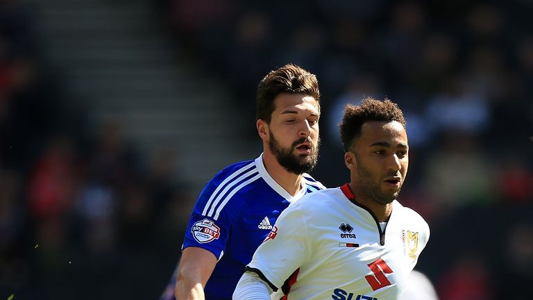 MILTON KEYNES, ENGLAND - APRIL 23:  Nicky Maynard of MK Dons holds off pressure from Yoann Barbet of Brentford during the Sky Bet Championship match betwee