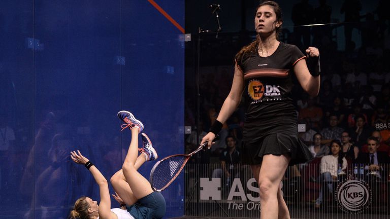 Nour El Sherbini of Egypt (R) celebrates a point as Laura Massaro of England falls down during their final match of the Women's World Squash Championships