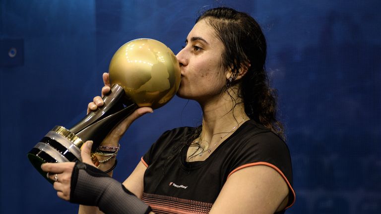 Nour El Sherbini of Egypt kisses the trophy after defeating  Laura Massaro of England the PSA Women's World Championships squash tournament