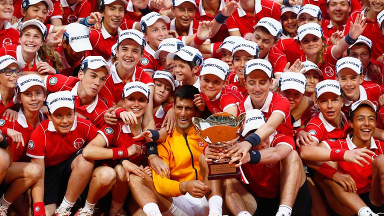 Novak Djokovic of Serbia celebrates the ball boys and girls