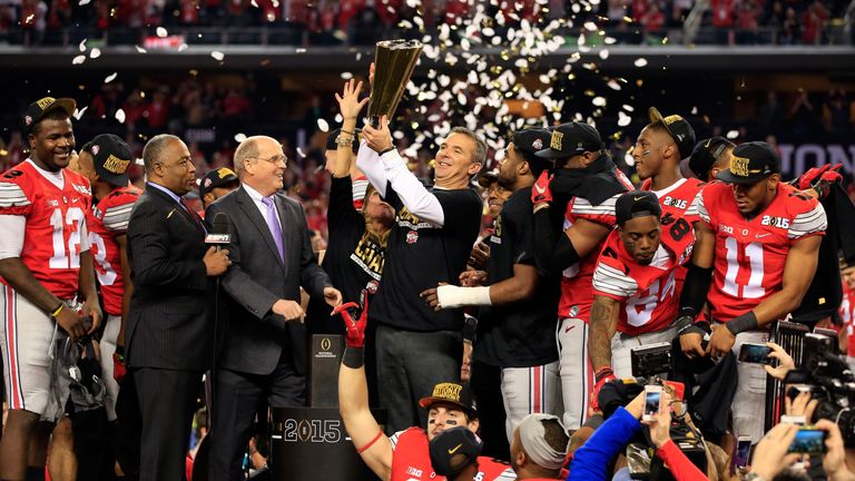 ARLINGTON, TX - JANUARY 12:  Head Coach Urban Meyer of the Ohio State Buckeyes hoist the trophy after defeating the Oregon Ducks 42 to 20 in the College Fo
