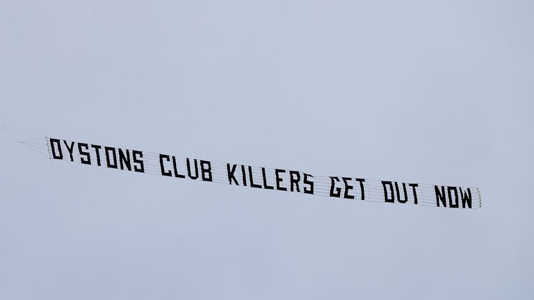 A protest banner reading 'Oystons club killers get out now' is flown over the stadium during the Sky Bet League One match Blackpool v Wigan