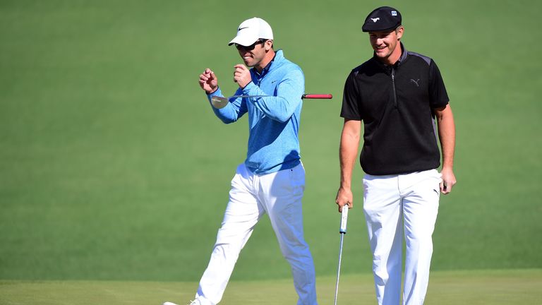 Paul Casey of England and amateur Bryson DeChambeau of the United States react on the second green during the first round of the Masters at Augusta