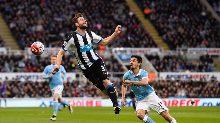 Paul Dummett can't stop the ball as Jesus Navas runs forward