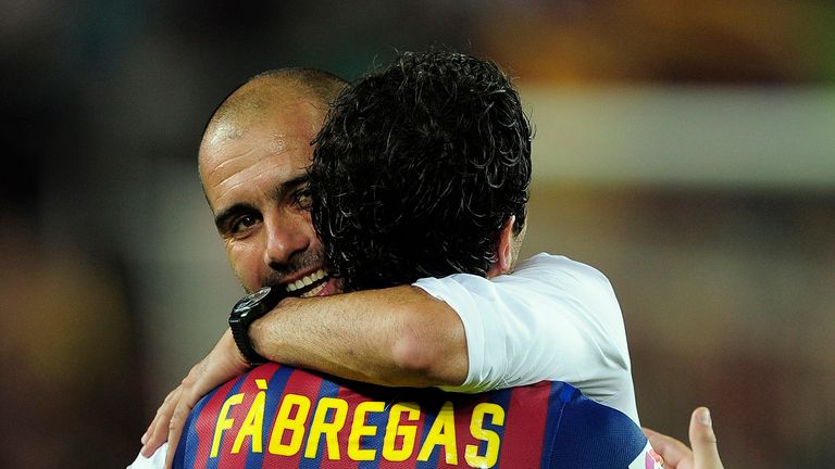 Barcelona's coach Josep Guardiola (L) celebrates with Barcelona's midfielder Cesc Fabregas after their victory on Real Madrid at the end of the second leg 