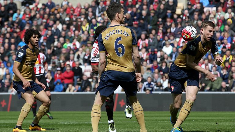 Jermain Defoe of Sunderland (obscured) has a shot blocked by Per Mertesacker 