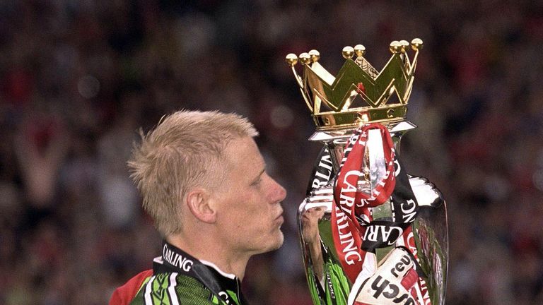 Peter Schmeichel of Manchester United kisses the FA Premiership trophy