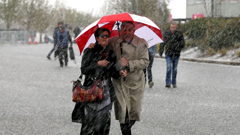 Racegoers shelter from the bad weather before the racing on day two of the Punchestown Festival at Punchestown, Co. Kildare, Ireland. PRESS ASSOCIATION Pho