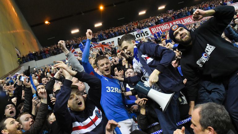 Rangers' Andy Halliday celebrates with the fans at full-time after winning the Championship title