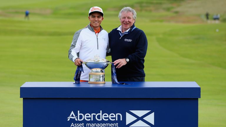 Rickie Fowler of the United States celebrates with the trophy alongside Martin Gilbert, Chief Executive of Aberdeen Asset Management