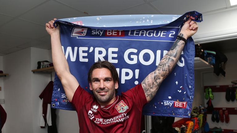 Ricky Holmes of Northampton Town celebrates promotion to League 1
