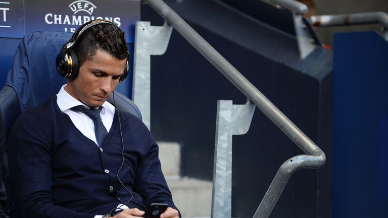 Real Madrid's Portuguese forward Cristiano Ronaldo sits in the dug-out ahead of kick off at the Etihad
