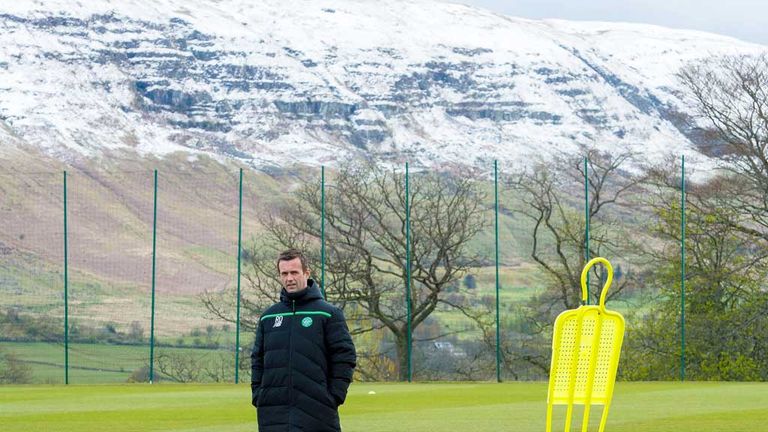 Celtic boss Ronny Deila strikes an isolated figure as he is pictured at the club's Lennoxtown training complex in the shadow of the Campsie Fells