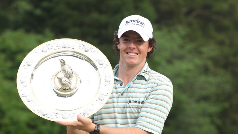 Rory McIlroy of Northern Ireland poses with the winner's trophy after his four-stroke victory at the 2010 Quail Hollow Championshi