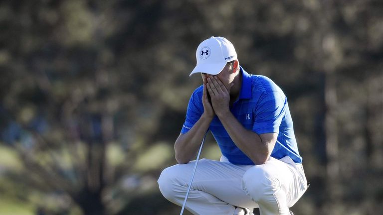 Jordan Spieth reacts as he waits to putt on the 18th green during the final round of the 2016 The Masters