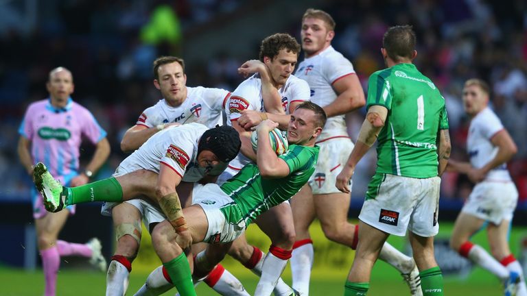 Ben Westwood (L) and Sean O'Loughlin of England tackle Ben Currie of Ireland during the 2013 Rugby League World Cup Group 