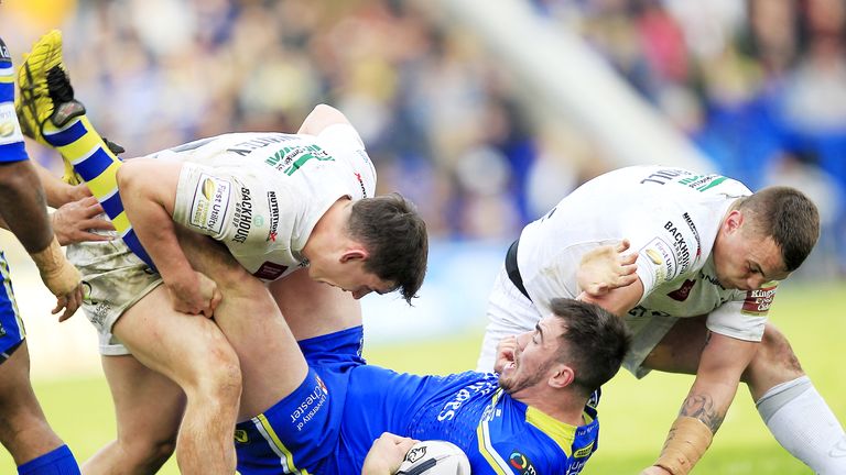 Jordan Cox tackled by Widnes duo Matt Whitley and Eamon O'Carroll during Warrington's win over the Vikings on March 25