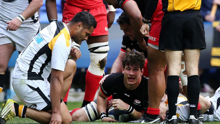 Michael Rhodes of Saracens dives over for a try against Wasps