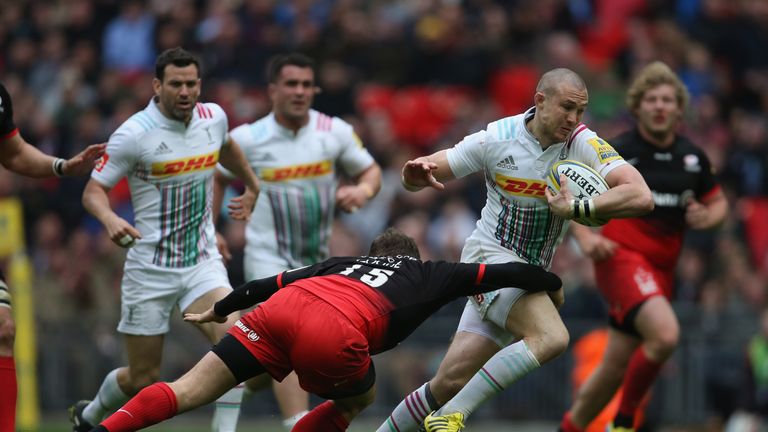 Mike Brown is tackled by Alex Goode of Saracens