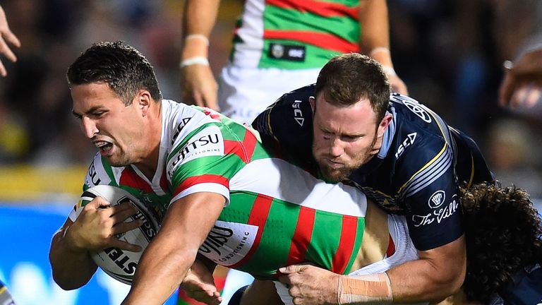 Sam Burgess of the Rabbitohs is tackled by Gavin Cooper  and Jake Granville of the Cowboys