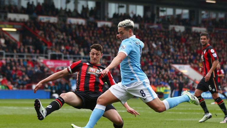 Tommy Elphick of Bournemouth tries to block a shot by Samir Nasri of Manchester City 