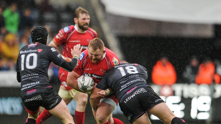 Scarlets' Samson Lee is tackled by Ospreys' Dimitri Arhip
