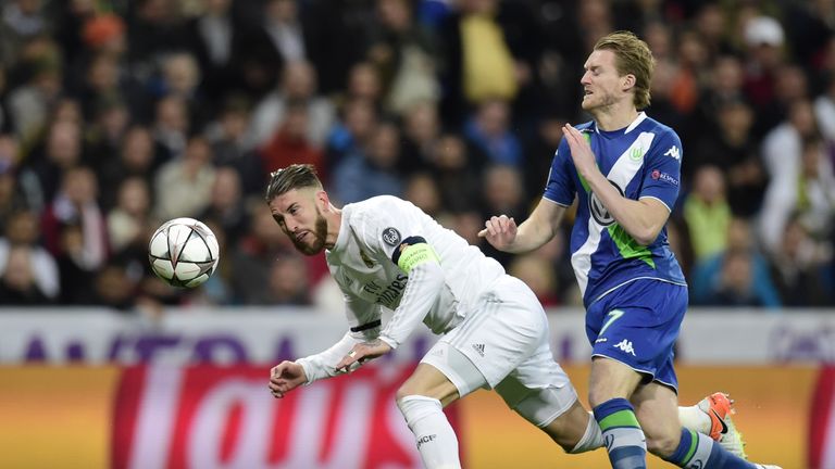 Real Madrid's defender Sergio Ramos (L) vies with Wolfsburg's midfielder Andre Schuerrle