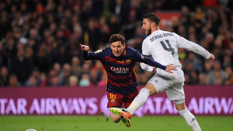 Sergio Ramos of Real Madrid CF battles for the ball with Lionel Messi of FC Barcelona