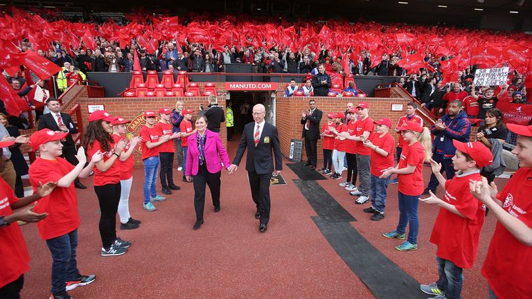 Sir Bobby Charlton and his wife Norma are presented to the Old Trafford crowd before the game 