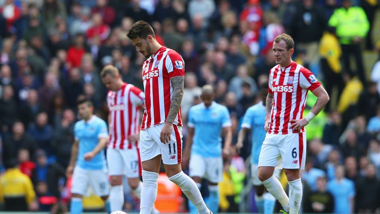 MANCHESTER, ENGLAND - APRIL 23:  Joselu of Stoke City and Glenn Whelan of Stoke City look dejected after Sergio Aguero of Manchester City scores the second