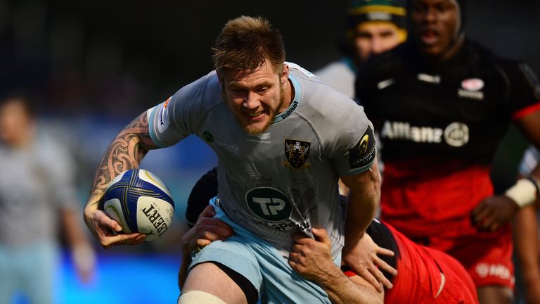 Teimana Harrison of Northampton Saints is tackled by Owen Farrell of Saracens