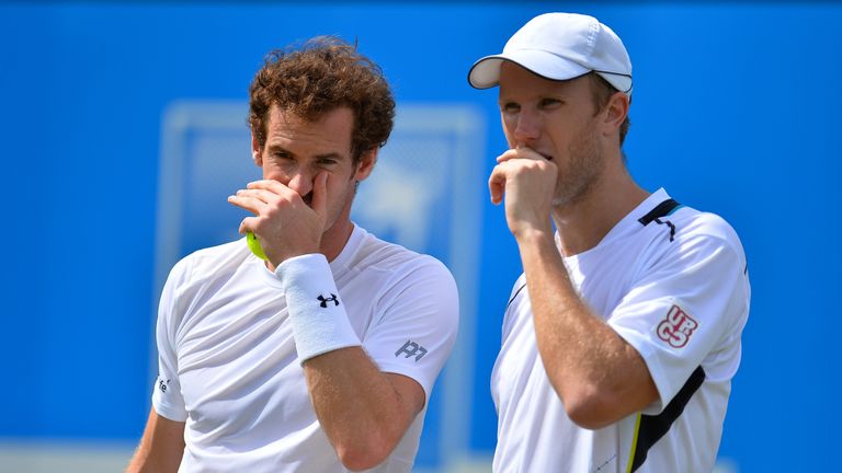 Andy Murray and Dominic Inglot of Great Britain discuss tactics in their men's doubles first round match